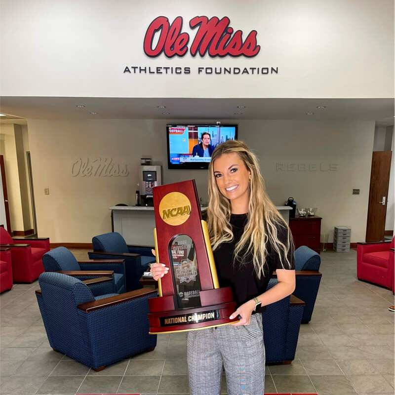 Madison holding NCAA trophy.